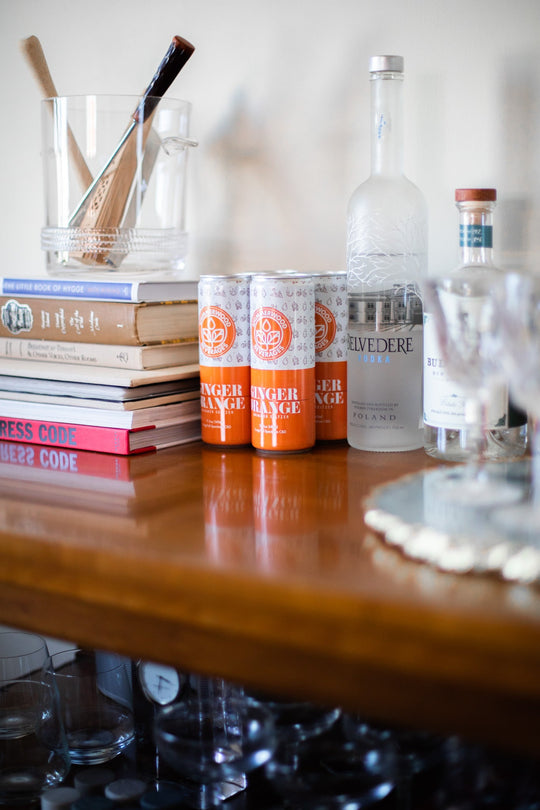 Ginger Orange seltzer on a bar cart for making mocktails